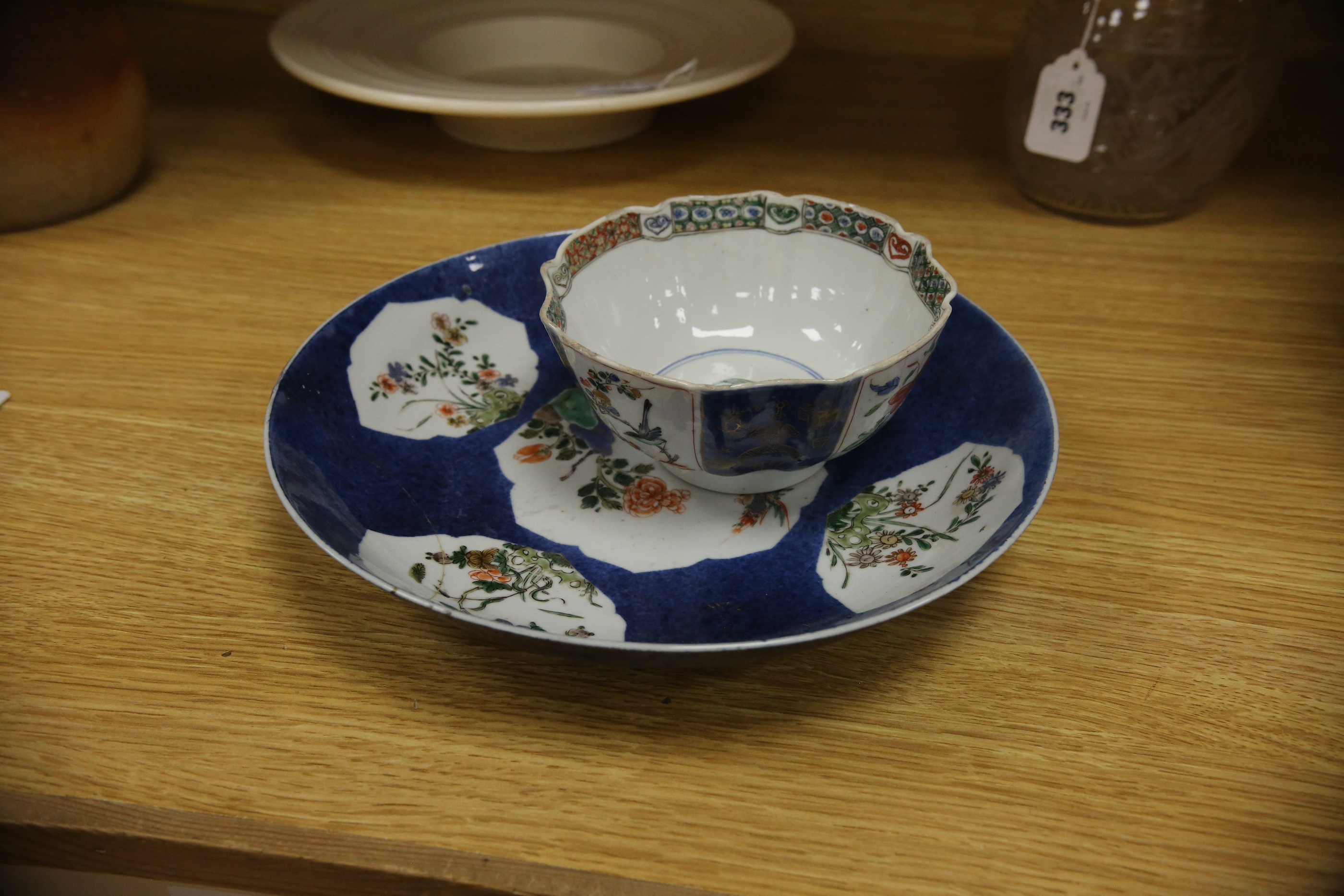 A Chinese famille verte powder blue ground bowl and a similar dish, both Kangxi period, 27.5cm diameter. Condition - dish poor, bowl fair